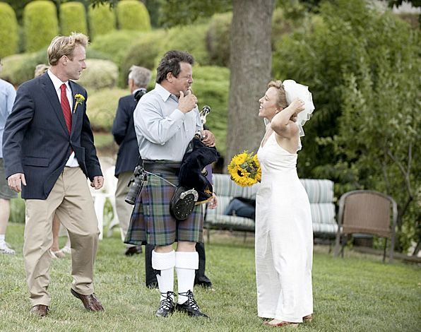 Tim Carey with his bagpipe talking to the bride