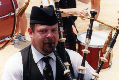 Tim Carey playing the bagpipe